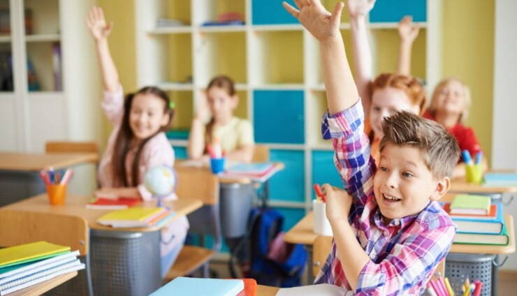 Students raising their hand to answer a question