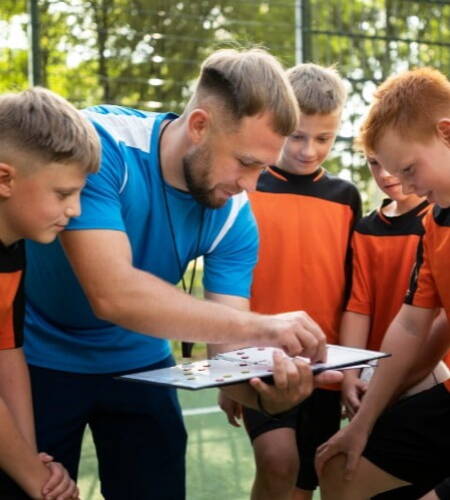 Sports coach explaining to students