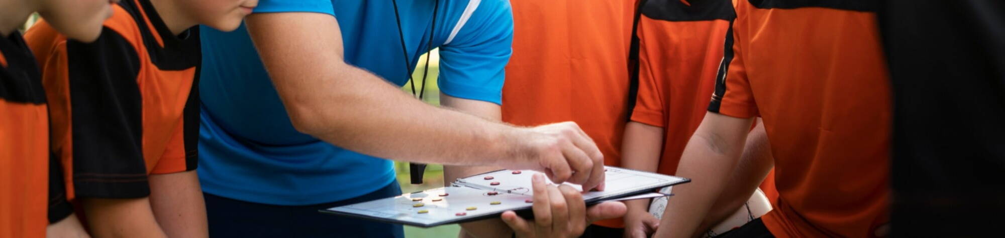 Sports coach explaining to students